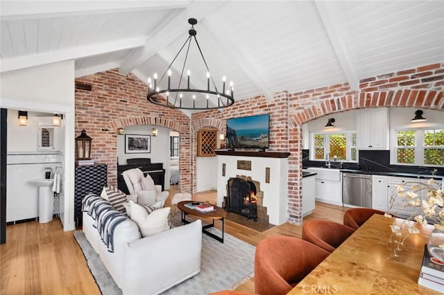 615 Seaview St, Laguna Beach, CA 92651 - living area featuring light wood-style floors, arched walkways, a chandelier, and brick wall