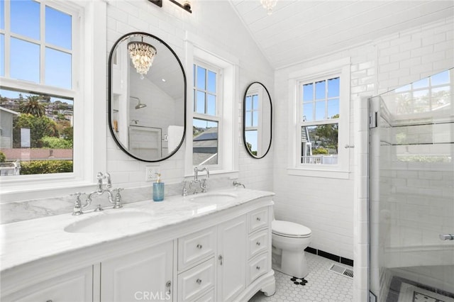 615 Seaview St, Laguna Beach, CA 92651 - full bath with lofted ceiling, double vanity, a shower stall, tile patterned flooring, and tile walls
