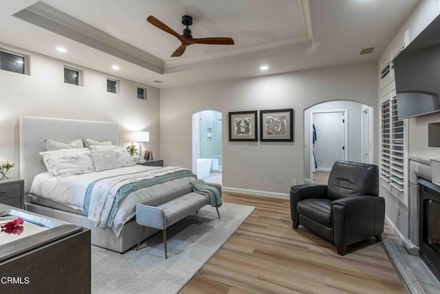 13115 Monarch Palm Ave, Bakersfield, CA 93314 - bedroom with arched walkways, a raised ceiling, ornamental molding, recessed lighting, and light wood finished floors