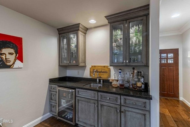 13115 Monarch Palm Ave, Bakersfield, CA 93314 - indoor bar with beverage cooler, dark wood-type flooring, crown molding, and recessed lighting