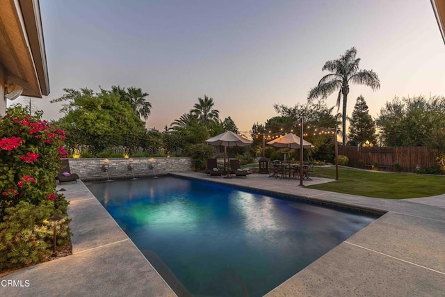 13115 Monarch Palm Ave, Bakersfield, CA 93314 - pool at dusk featuring a fenced backyard and a patio area