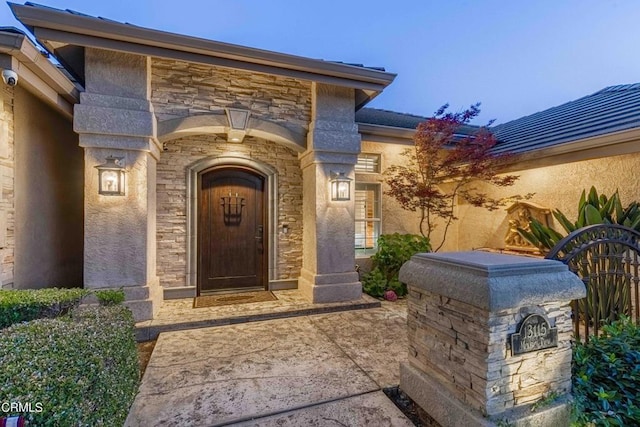 13115 Monarch Palm Ave, Bakersfield, CA 93314 - doorway to property featuring stone siding, stucco siding, and a security system