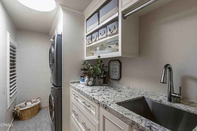 13115 Monarch Palm Ave, Bakersfield, CA 93314 - laundry room featuring stacked washing machine and dryer and cabinet space