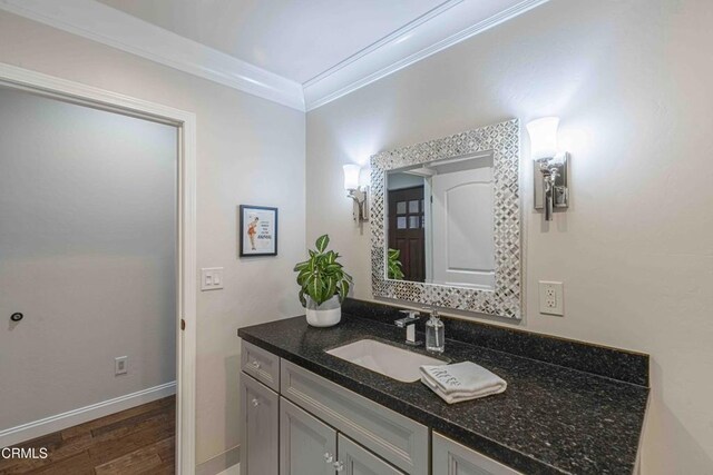 13115 Monarch Palm Ave, Bakersfield, CA 93314 - bathroom featuring ornamental molding, vanity, and wood finished floors