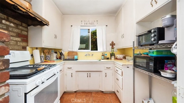 7117 Shadygrove St, Tujunga, CA 91042 - kitchen with white gas range oven, wall chimney range hood, light countertops, and white cabinetry