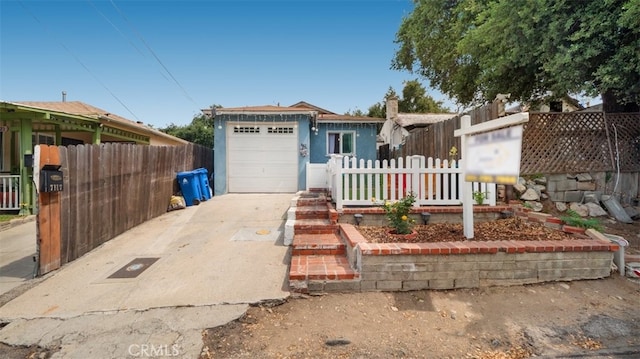 7117 Shadygrove St, Tujunga, CA 91042 - view of front of property featuring an attached garage, concrete driveway, and stucco siding