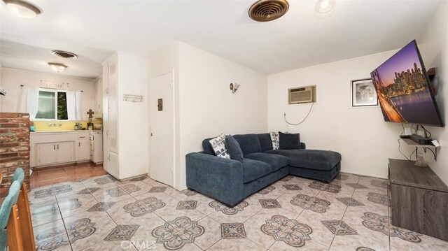 7117 Shadygrove St, Tujunga, CA 91042 - living area featuring light tile patterned floors and a wall mounted air conditioner