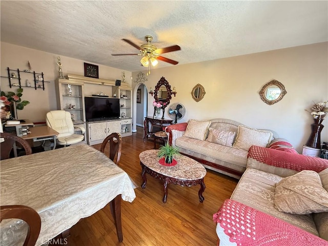 14047 Pierce St, Arleta, CA 91331 - living area featuring arched walkways, a ceiling fan, wood finished floors, and a textured ceiling