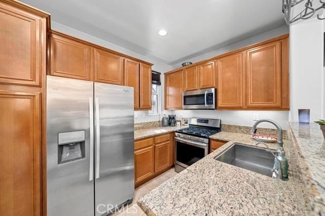 31054 Strawberry Tree Ln Unit 5, Temecula, CA 92592 - kitchen featuring stainless steel appliances, light stone countertops, brown cabinetry, and recessed lighting