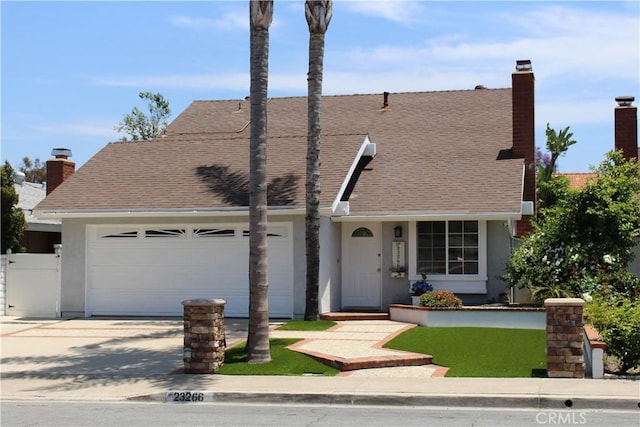 23266 Via Ronda, Mission Viejo, CA 92691 - view of front of home featuring driveway, an attached garage, stucco siding, a chimney, and roof with shingles