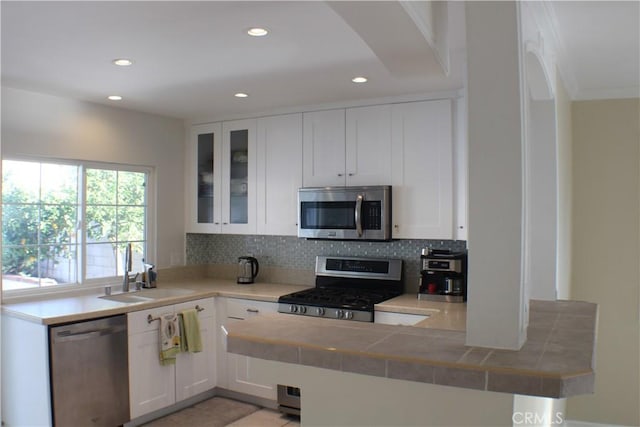 23266 Via Ronda, Mission Viejo, CA 92691 - kitchen with appliances with stainless steel finishes, backsplash, recessed lighting, white cabinets, and glass insert cabinets