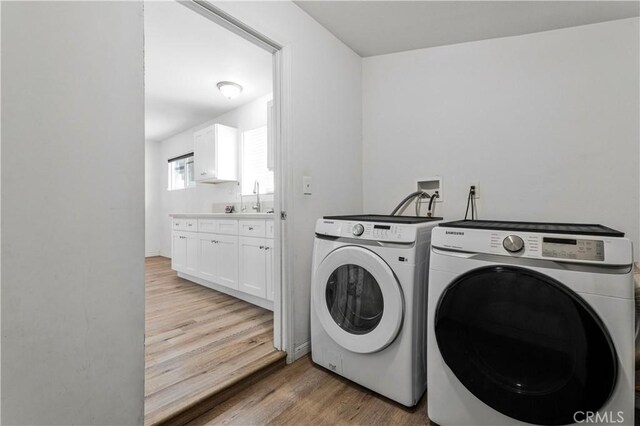 455 E Wilson St, Rialto, CA 92376 - laundry room with washer and dryer and light wood-type flooring