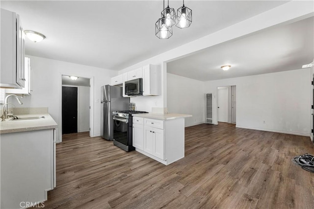 455 E Wilson St, Rialto, CA 92376 - kitchen with stainless steel appliances, wood finished floors, open floor plan, light countertops, and white cabinets