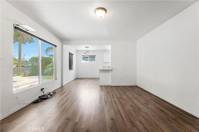 455 E Wilson St, Rialto, CA 92376 - unfurnished living room with wood finished floors and baseboards