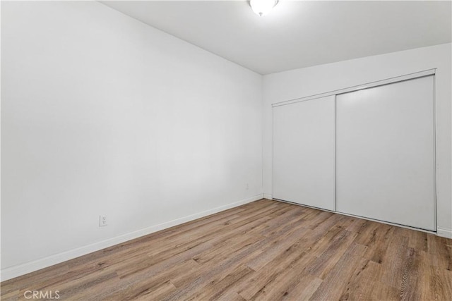 455 E Wilson St, Rialto, CA 92376 - unfurnished bedroom featuring wood finished floors and a closet