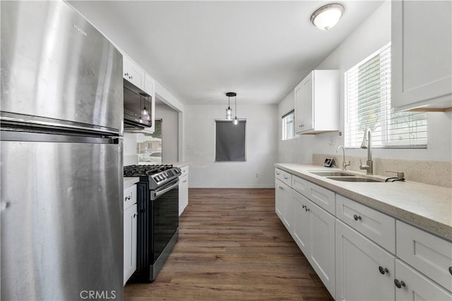 455 E Wilson St, Rialto, CA 92376 - kitchen featuring appliances with stainless steel finishes, white cabinetry, light countertops, and dark wood finished floors