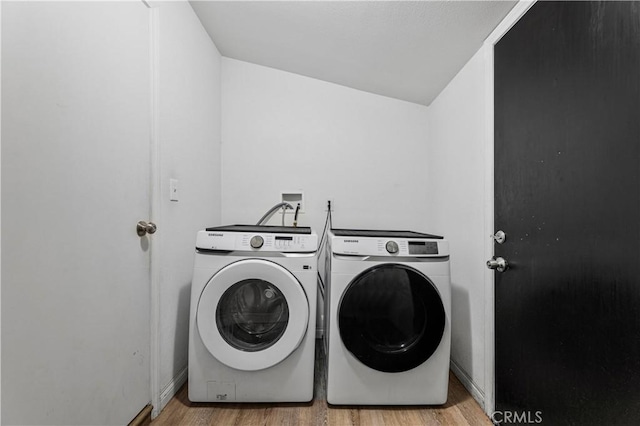 455 E Wilson St, Rialto, CA 92376 - washroom featuring washing machine and dryer and wood finished floors