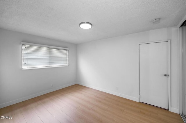 6552 Neddy Ave, West Hills, CA 91307 - unfurnished bedroom with a textured ceiling and wood finished floors