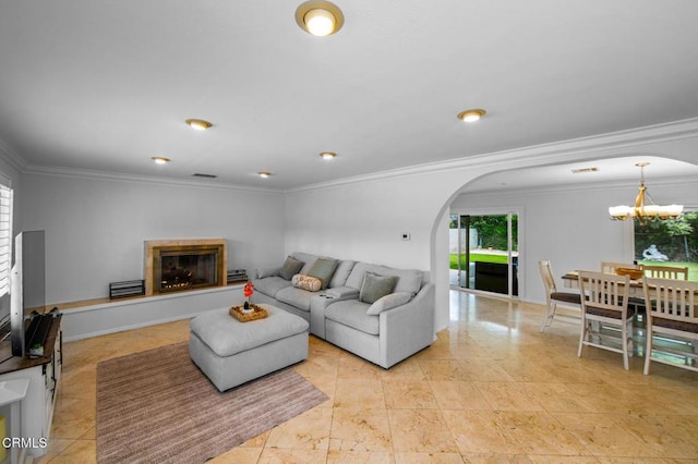 6552 Neddy Ave, West Hills, CA 91307 - living room featuring arched walkways, a chandelier, a glass covered fireplace, and crown molding