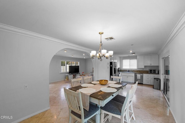 6552 Neddy Ave, West Hills, CA 91307 - dining room featuring ornamental molding, a chandelier, and arched walkways