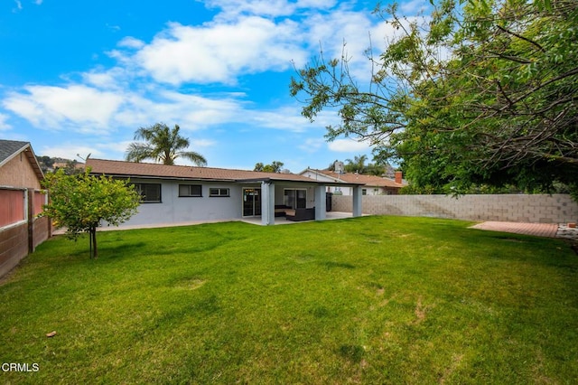 6552 Neddy Ave, West Hills, CA 91307 - back of house with a fenced backyard, stucco siding, and a patio
