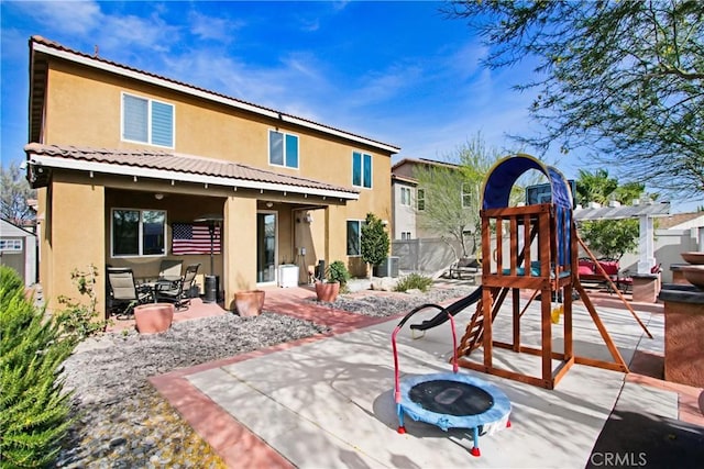 11543 Sky Pointe Dr, Desert Hot Springs, CA 92240 - back of property featuring stucco siding, a patio area, and an outdoor fire pit