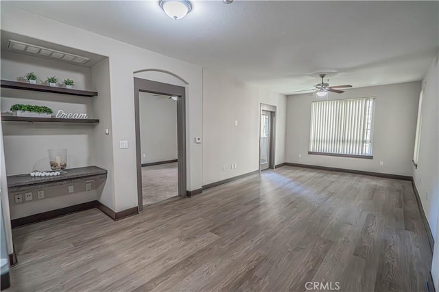 24595 Town Center Dr Unit 3205, Valencia, CA 91355 - spare room featuring ceiling fan, wood finished floors, and arched walkways