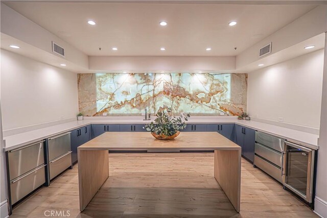 24595 Town Center Dr Unit 3205, Valencia, CA 91355 - kitchen featuring beverage cooler, a kitchen island, light wood-style floors, recessed lighting, and light countertops