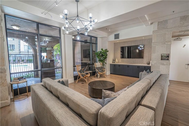 24595 Town Center Dr Unit 3205, Valencia, CA 91355 - living room with wood finished floors and a chandelier