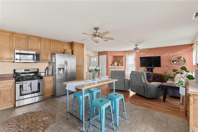 249 Colt Ln, Nipomo, CA 93444 - kitchen with appliances with stainless steel finishes, ceiling fan, light stone finish flooring, and light brown cabinetry