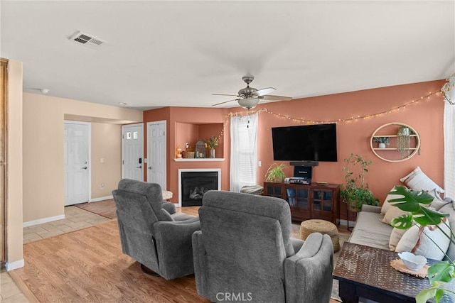 249 Colt Ln, Nipomo, CA 93444 - living room with a fireplace, ceiling fan, and light wood-style floors