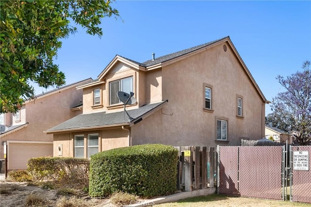 249 Colt Ln, Nipomo, CA 93444 - view of side of home with stucco siding, a garage, and a gate