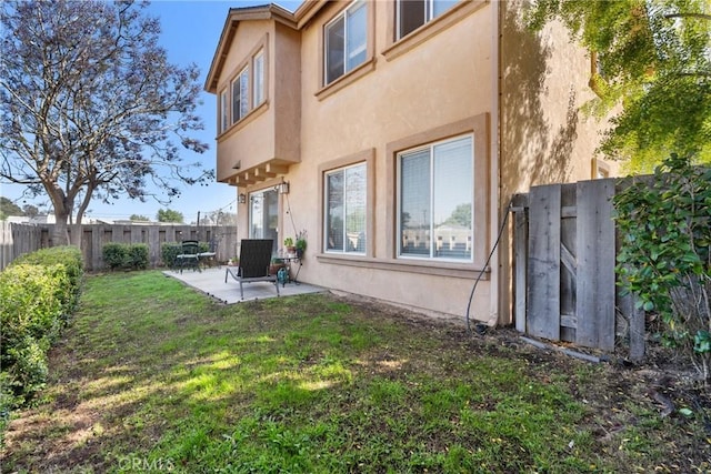 249 Colt Ln, Nipomo, CA 93444 - back of property featuring stucco siding, a patio area, and a fenced backyard