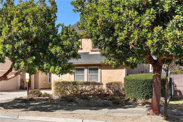 249 Colt Ln, Nipomo, CA 93444 - view of property hidden behind natural elements with stucco siding and driveway