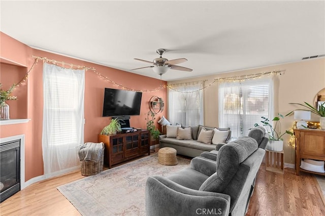 249 Colt Ln, Nipomo, CA 93444 - living room with a ceiling fan, light wood finished floors, and a glass covered fireplace