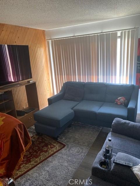 1317 W Cypress Ave Unit A2, Lompoc, CA 93436 - living area with a textured ceiling and wood walls