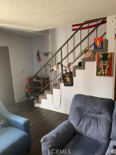 1317 W Cypress Ave Unit A2, Lompoc, CA 93436 - stairway with wood finished floors and a textured ceiling