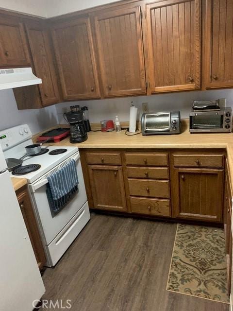 1317 W Cypress Ave Unit A2, Lompoc, CA 93436 - kitchen with under cabinet range hood, electric range, light countertops, dark wood finished floors, and brown cabinets