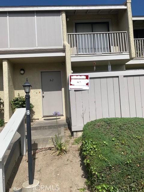 1317 W Cypress Ave Unit A2, Lompoc, CA 93436 - property entrance with a balcony and stucco siding