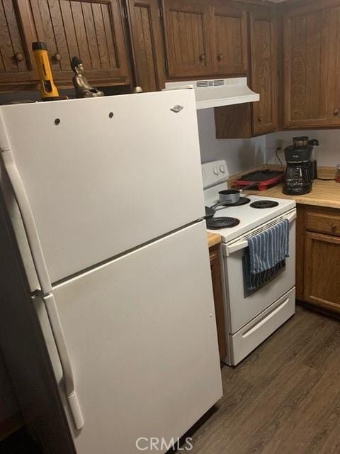 1317 W Cypress Ave Unit A2, Lompoc, CA 93436 - kitchen with white appliances, under cabinet range hood, dark wood-type flooring, and light countertops