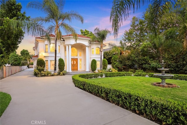 1118 S 6th Ave, Arcadia, CA 91006 - mediterranean / spanish-style house with driveway, stucco siding, and a lawn