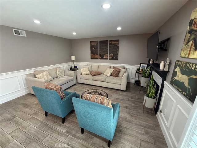 1053 Border Ave, Corona, CA 92882 - living area with wood finished floors, wainscoting, recessed lighting, and a decorative wall