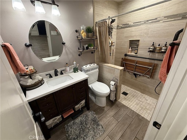 1053 Border Ave, Corona, CA 92882 - full bathroom featuring wood finished floors, vanity, and tiled shower