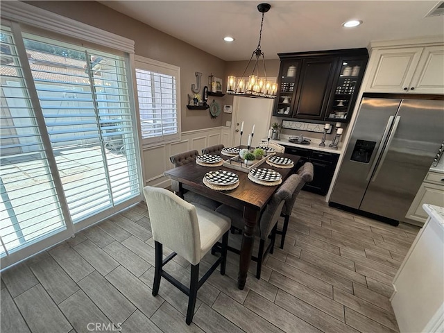 1053 Border Ave, Corona, CA 92882 - dining room with wood finish floors, a wainscoted wall, a chandelier, recessed lighting, and a decorative wall