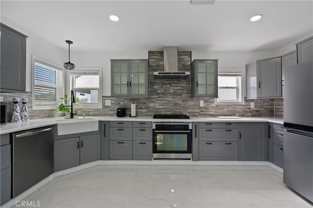 1381 W Summerland Ave, San Pedro, CA 90732 - kitchen with appliances with stainless steel finishes, gray cabinets, wall chimney range hood, tasteful backsplash, and glass insert cabinets