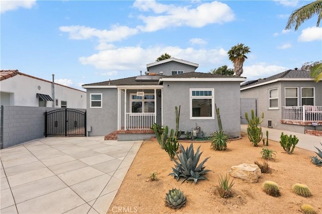 1381 W Summerland Ave, San Pedro, CA 90732 - view of front of property featuring a gate, stucco siding, and solar panels