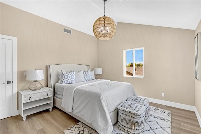 22461 Silver Spur, Lake Forest, CA 92630 - bedroom with a chandelier, lofted ceiling, and light wood finished floors