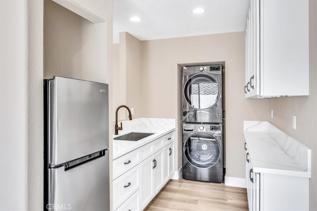 22461 Silver Spur, Lake Forest, CA 92630 - washroom featuring estacked washer and dryer, light wood-type flooring, and recessed lighting