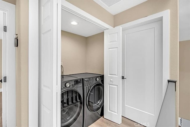 22461 Silver Spur, Lake Forest, CA 92630 - laundry area with washing machine and clothes dryer and light wood-style flooring