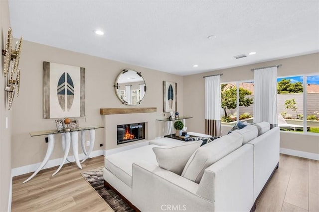 22461 Silver Spur, Lake Forest, CA 92630 - living area featuring light wood finished floors, recessed lighting, and a glass covered fireplace